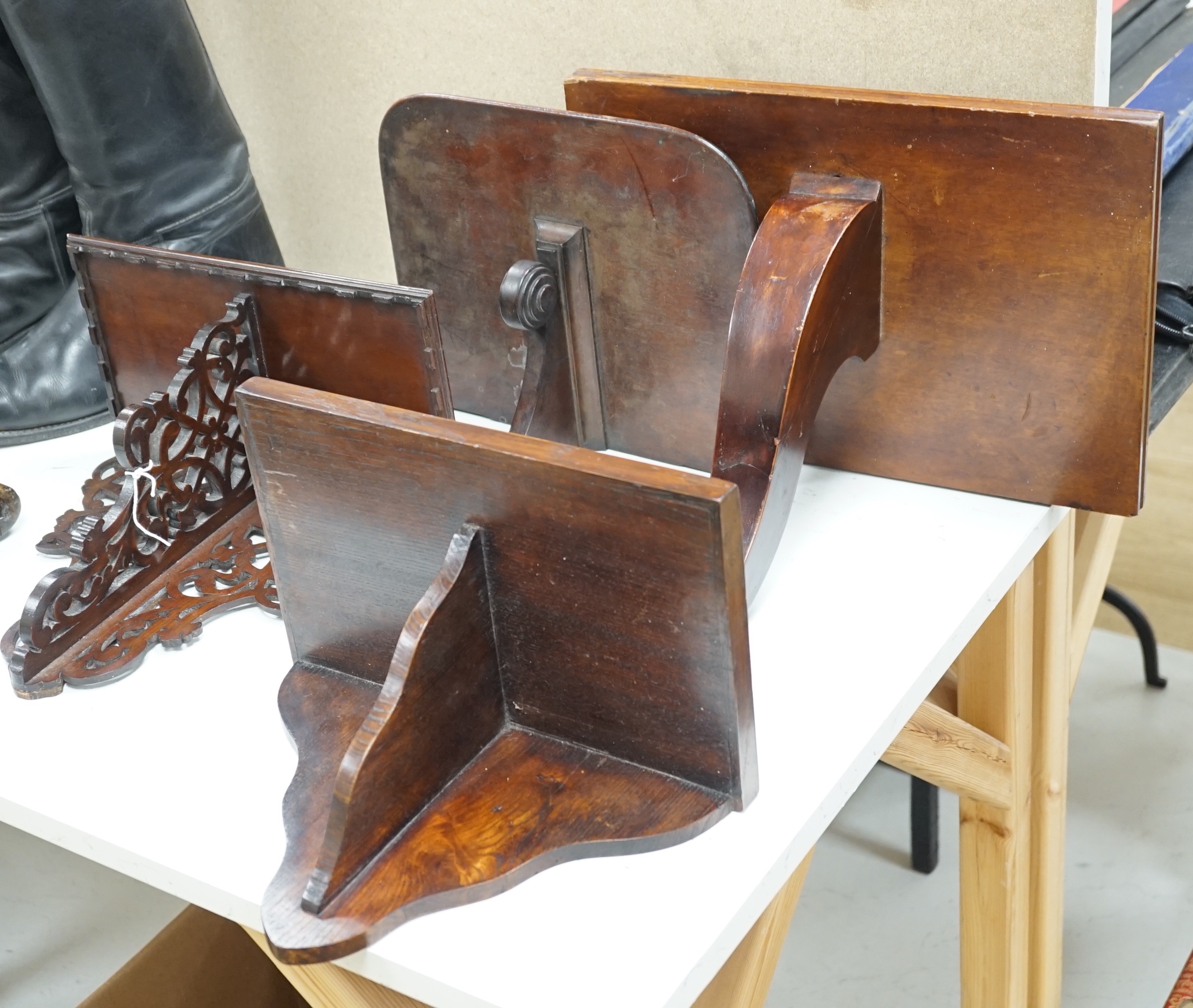 Four carved mahogany or oak wall brackets, largest 34x39cm